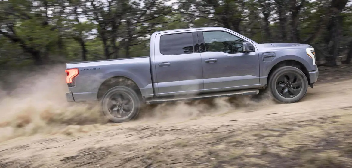 An F-150 Lightning kicking up dust off-road