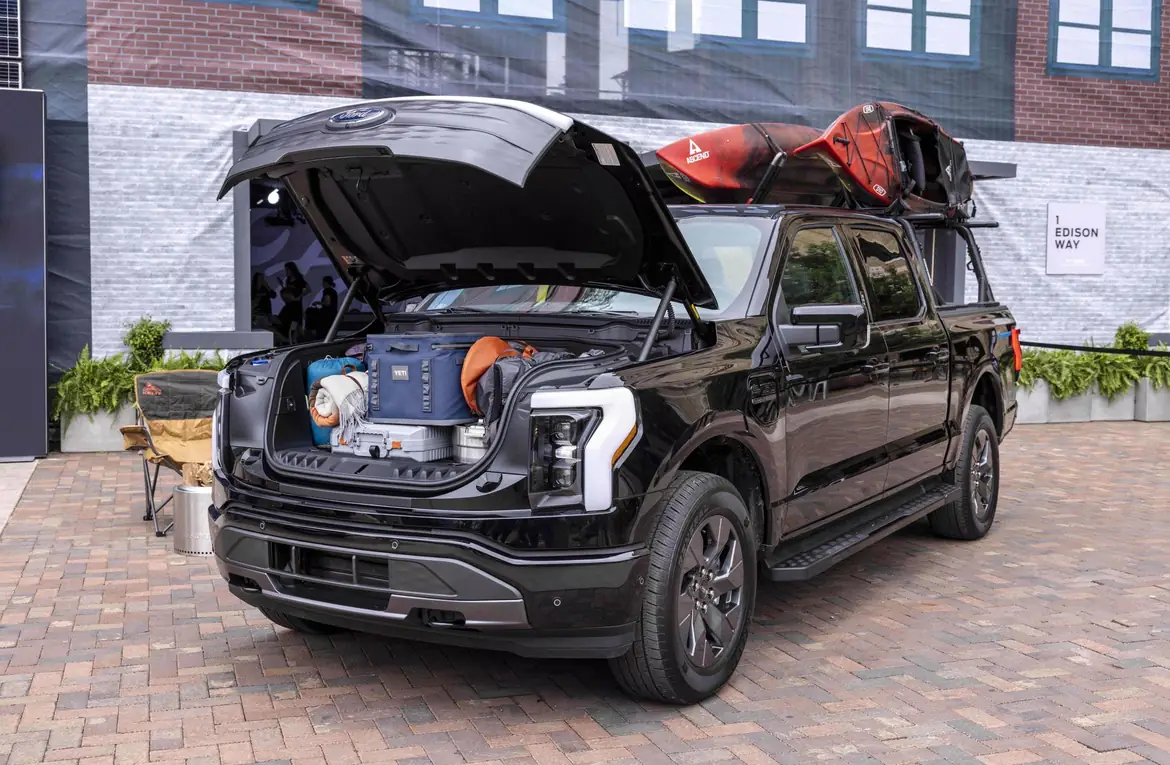 An F-150 Lightning with its Mega Power Frunk open and loaded