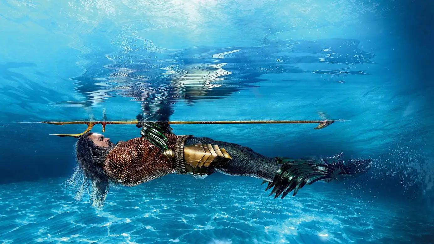 Aquaman floating beneath the surface with his trident