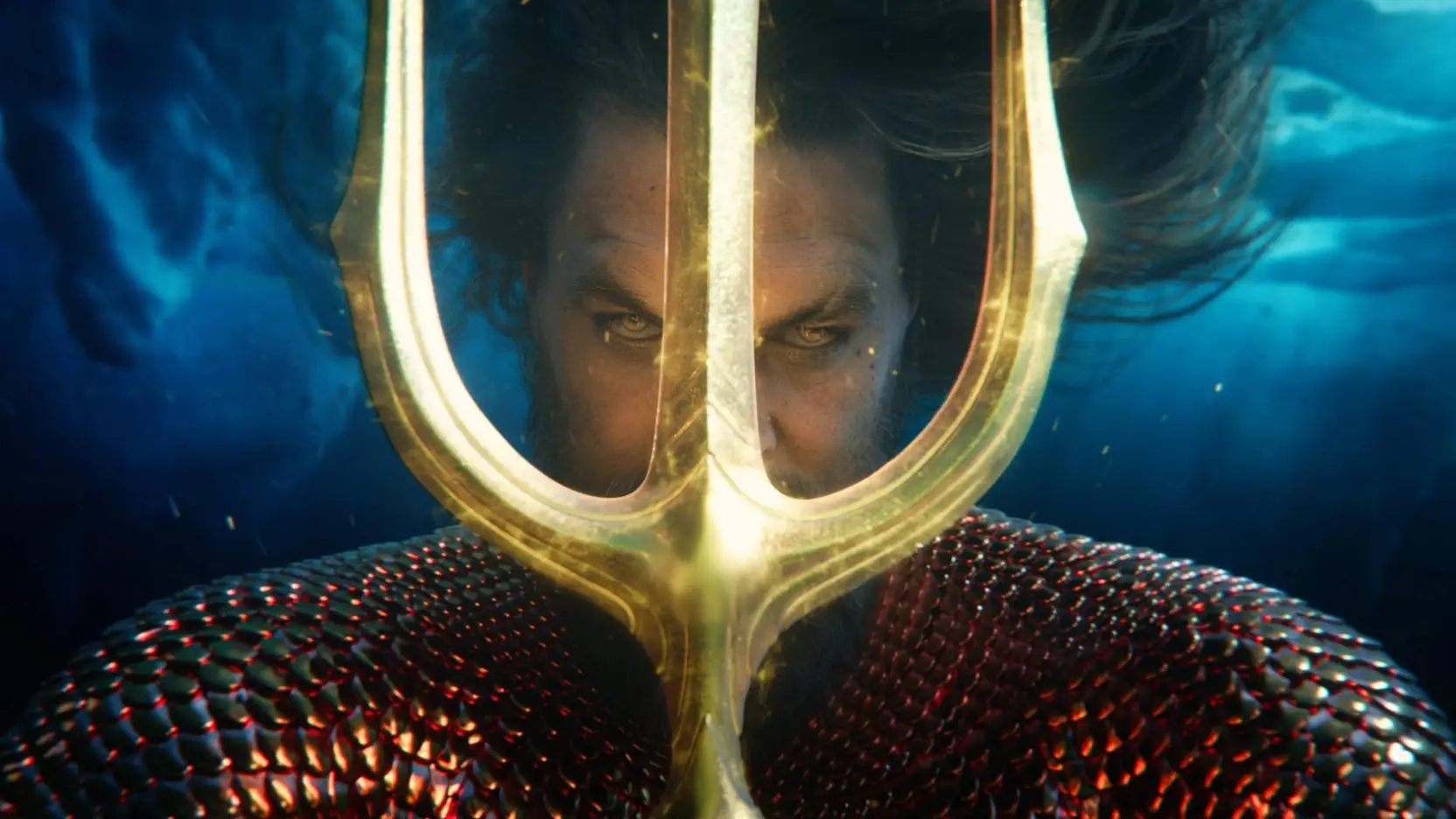 Arthur behind the golden trident underwater