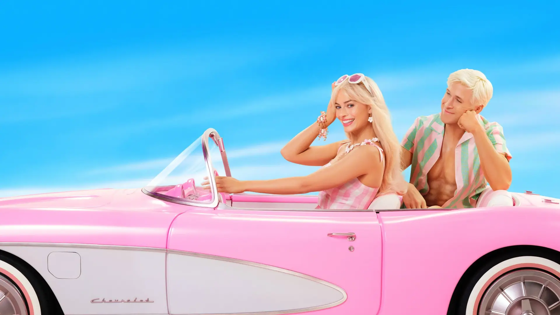 Barbie and Ken in a pink convertible