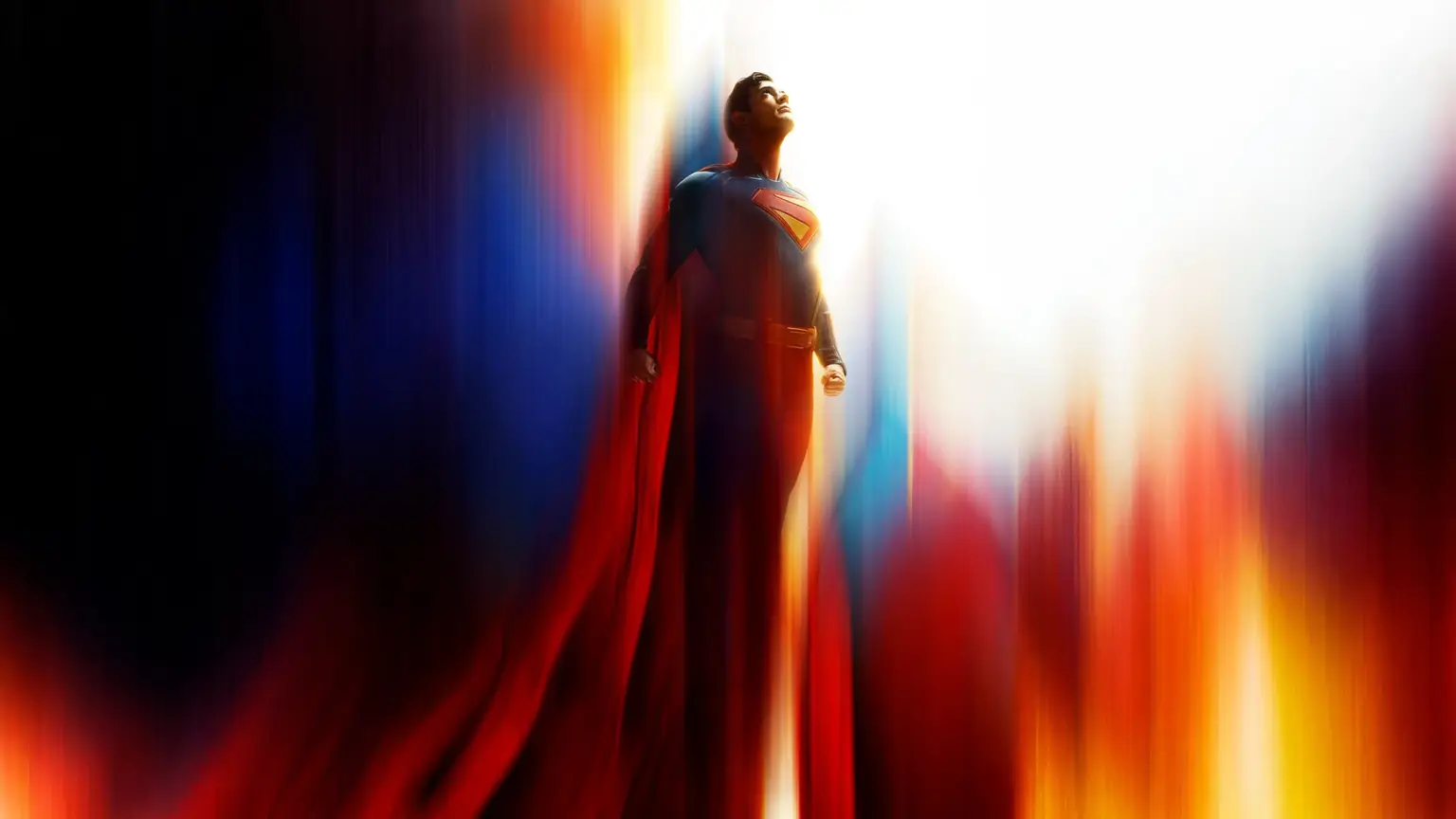 Superman from the 2025 film floats against a vibrant, abstract background of bright light and vertical streaks of blue…