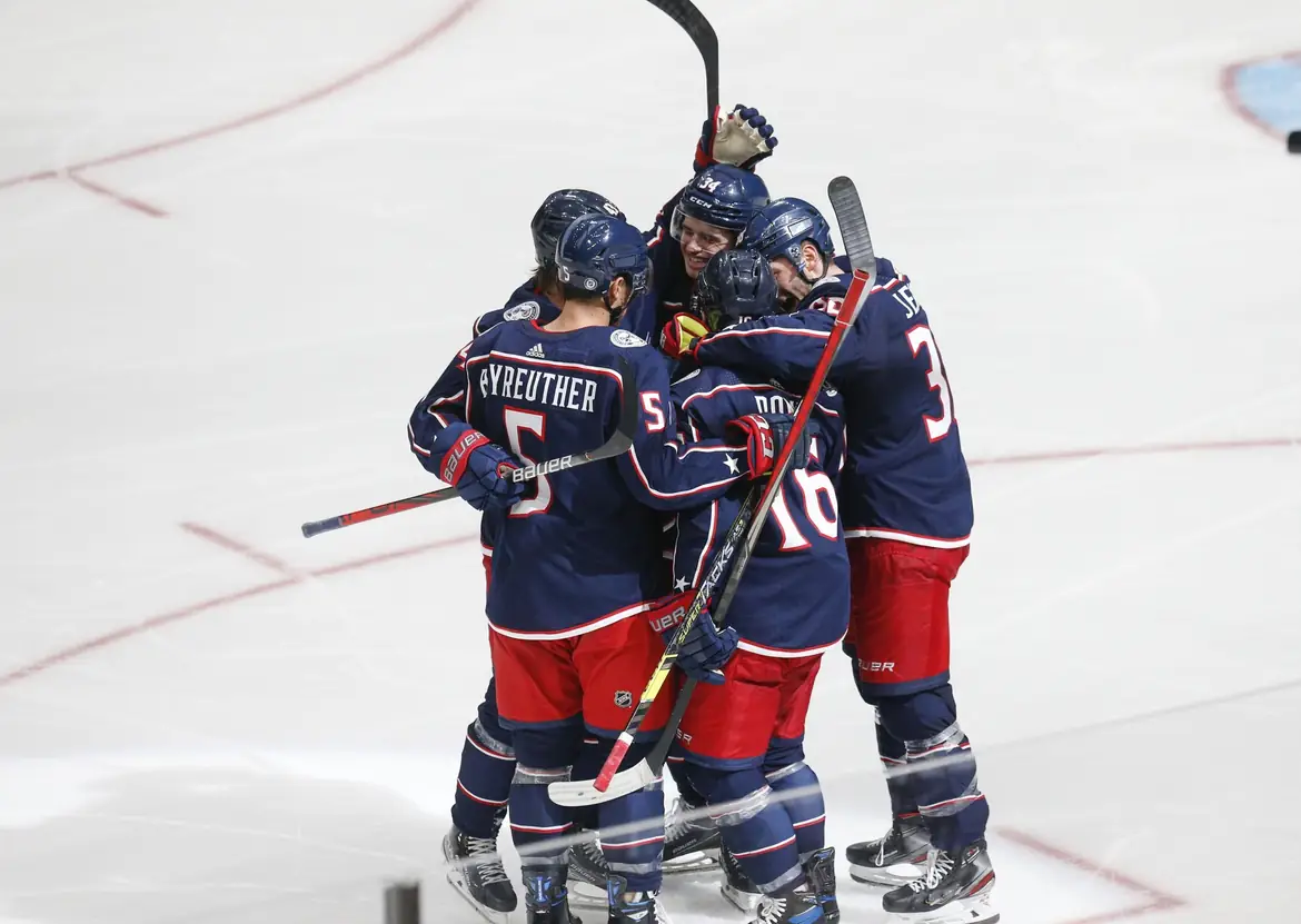 Columbus Blue Jackets players in a goal huddle