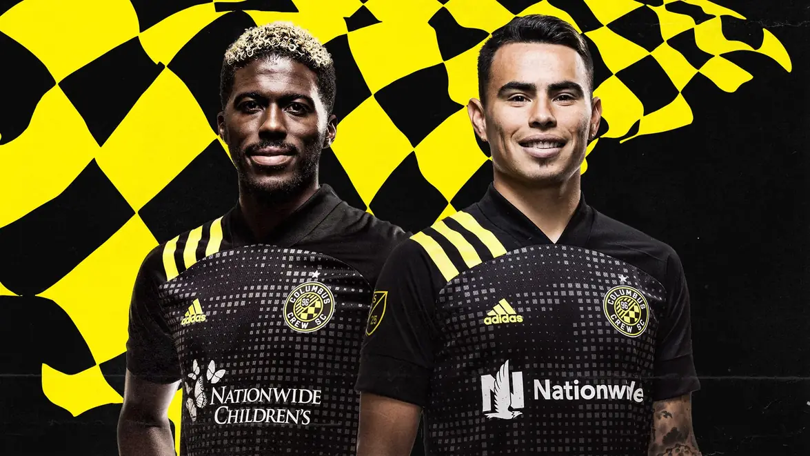Crew players in the 2020 kits against a black and gold checker