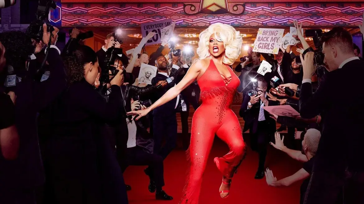 RuPaul on the red carpet as photographers crowd in