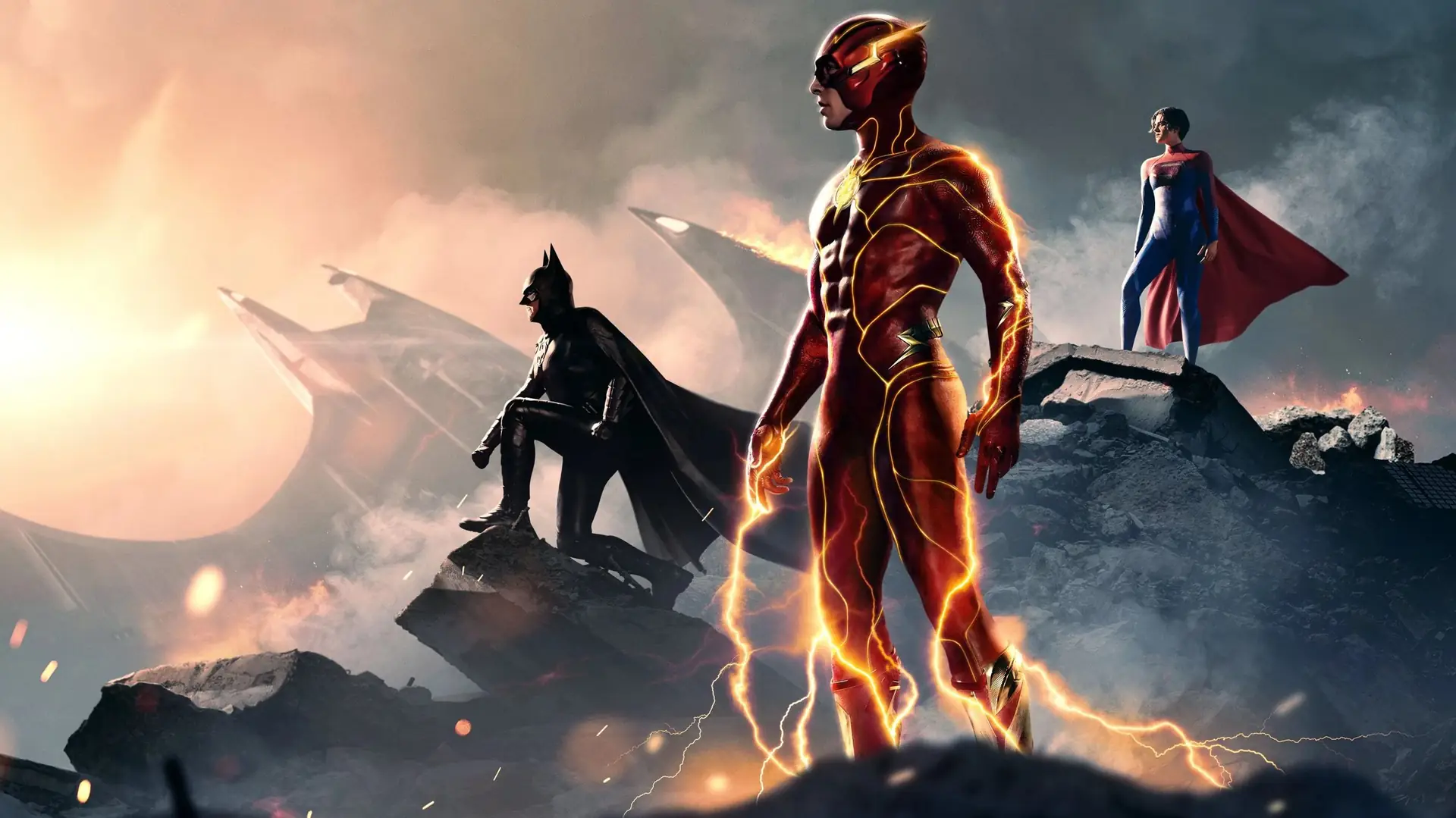 Batman, The Flash, and Supergirl stand atop rubble in a dramatic scene with lightning effects.