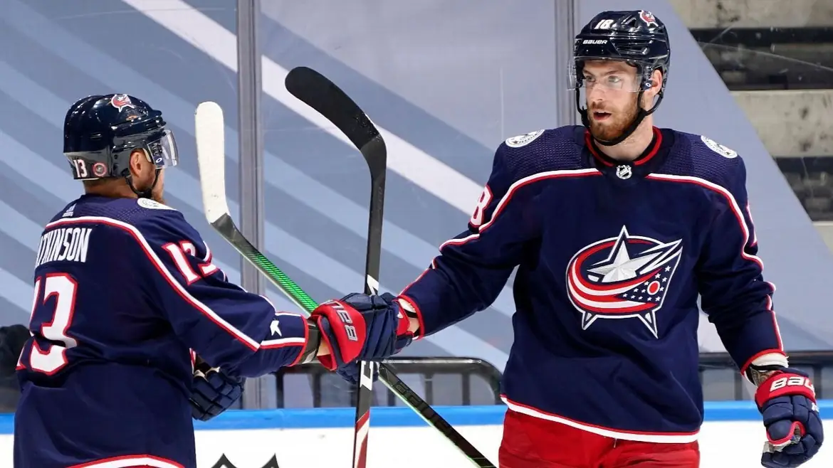 Two Columbus Blue Jackets players bumping gloves